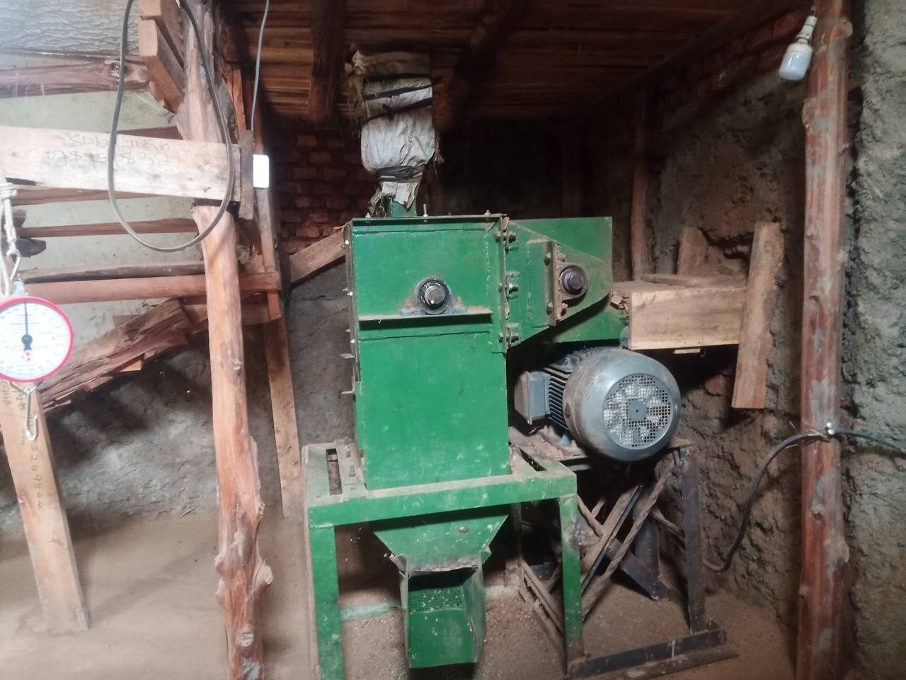 The estate's dry mill &mdash; the green milling machine and motor inside the processing shed